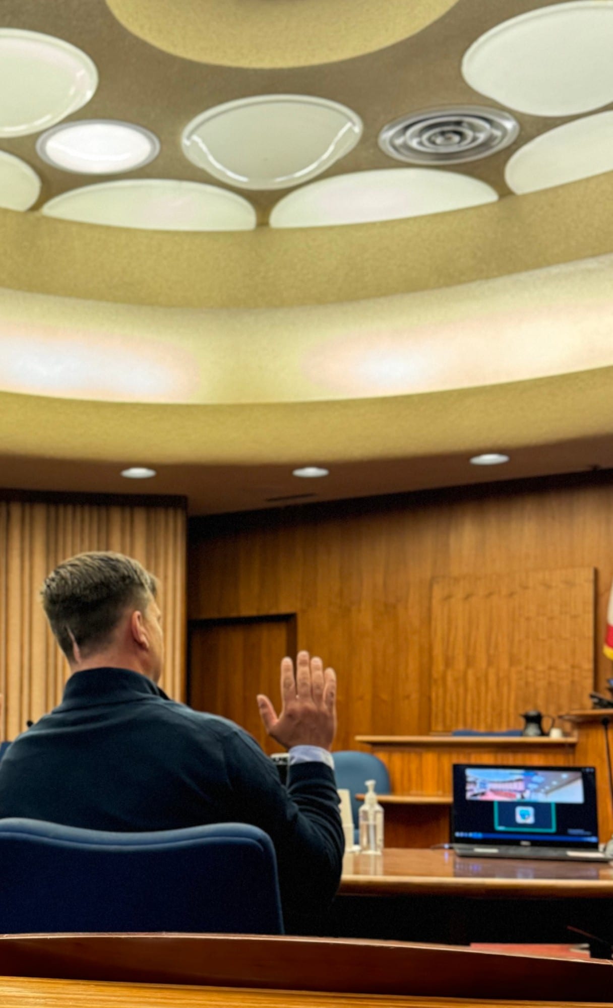 Mike Little being sworn in at a Marin County courtroom, right hand raised